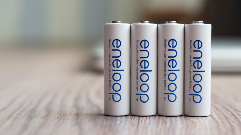 Close-up of four Eneloop rechargeable batteries organized on a table.