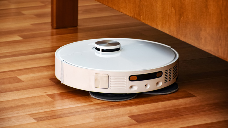 Robot vacuum on a wooden floor