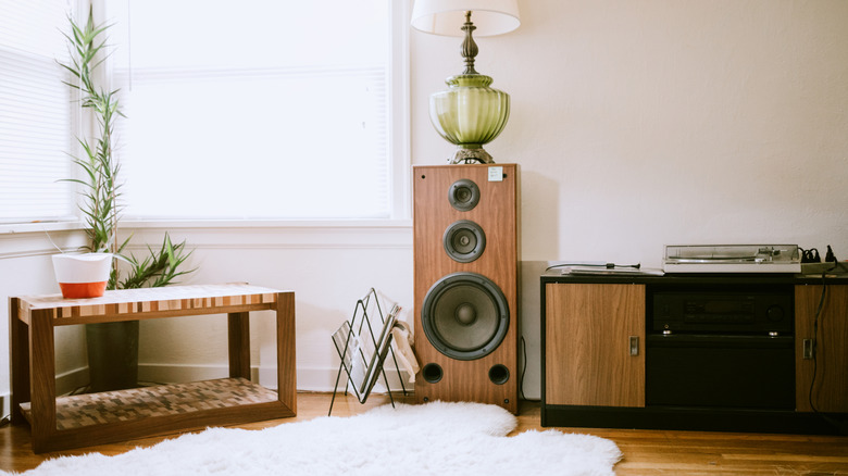 A living room with a wood finish tower speaker