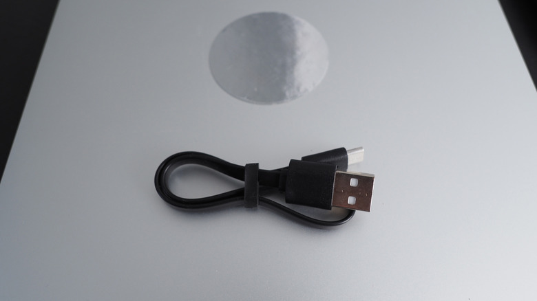 A USB-C cable placed on a laptop