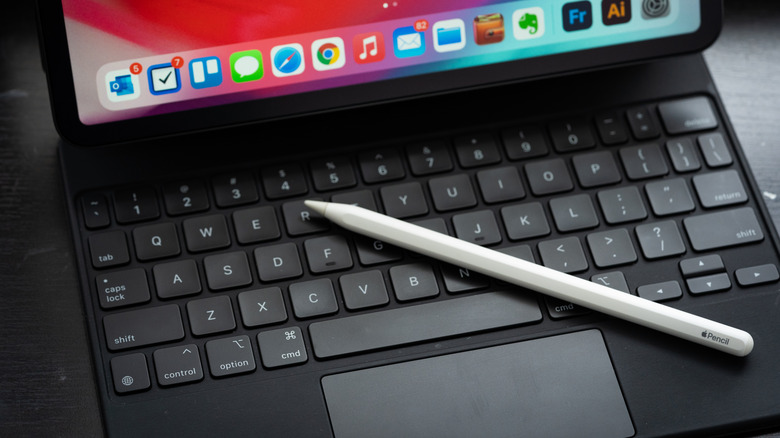 An Apple Pencil and Magic Keyboard, connected to an iPad.