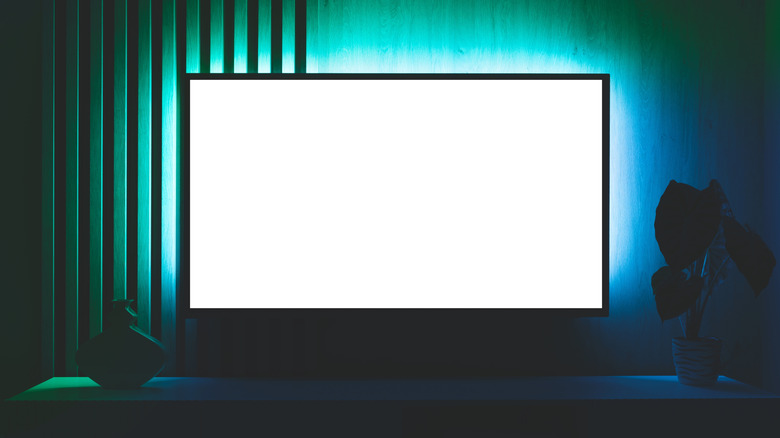 Modern living room interior with blank white smart TV screen.