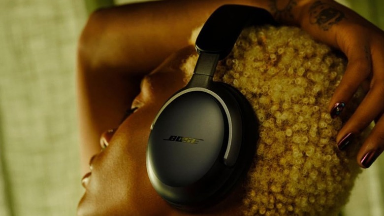 A person wearing the Bose QuietComfort Ultra wireless headphones.