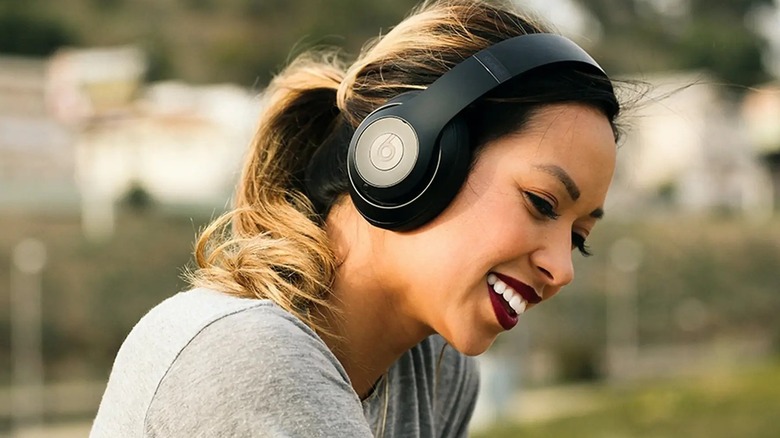 A woman wearing beats studio 3 headphones
