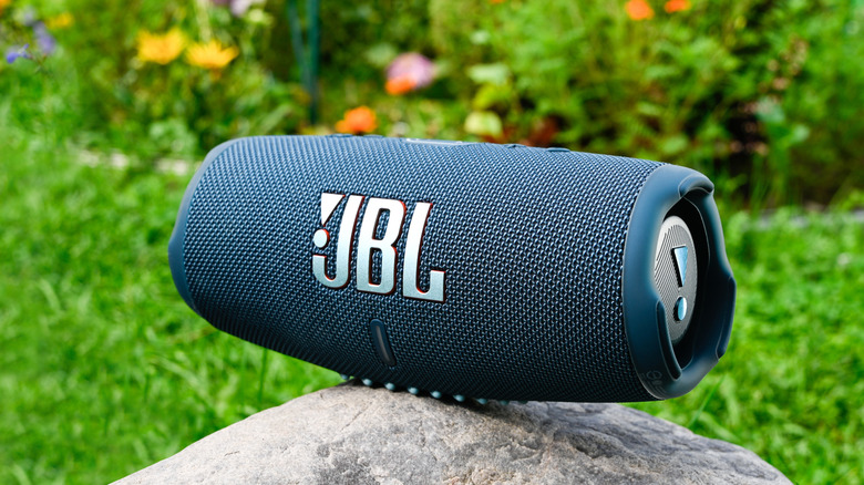 jbl charge 5 speaker sitting in an outdoor environment