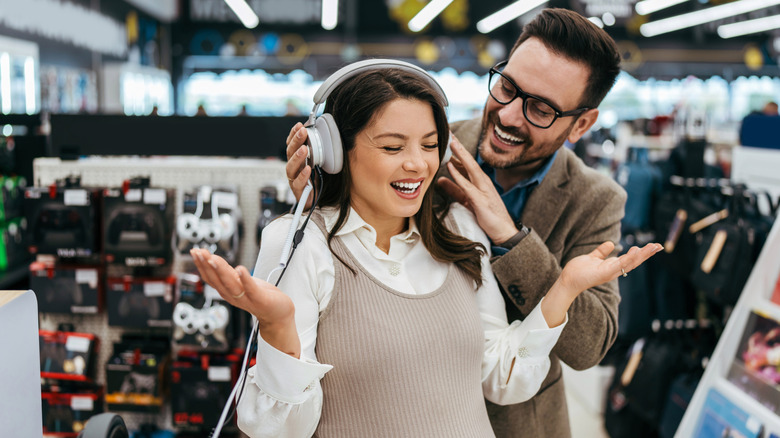 Person trying out headphones at a store