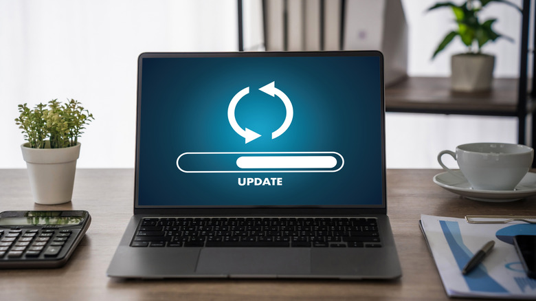 A laptop showing an update icon on its screen.