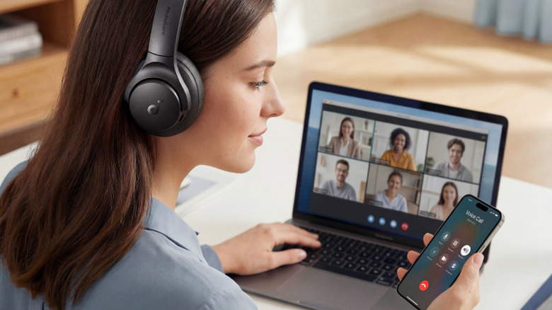 A person wearing the Anker SoundCore Q20i noise-canceling headphones while in a video call.