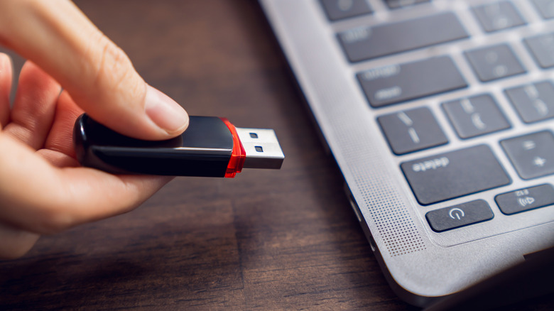 USB drive going into a laptop