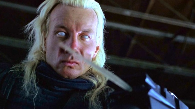 Talec with eerie white eyes staring at his blade