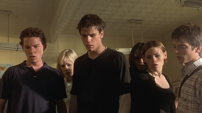 The students looking at something on the floor in shock