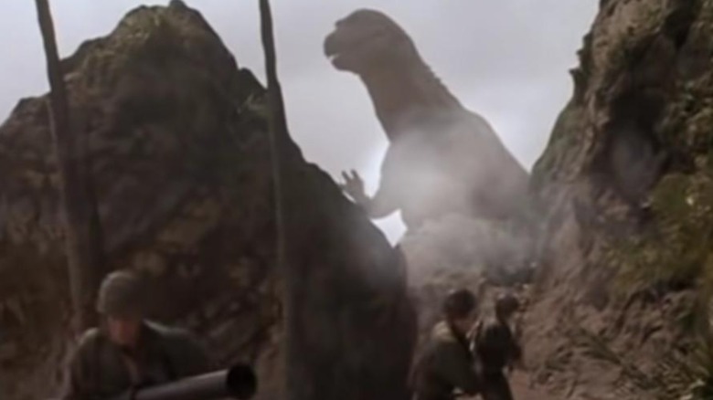 Godzilla towering over soliders