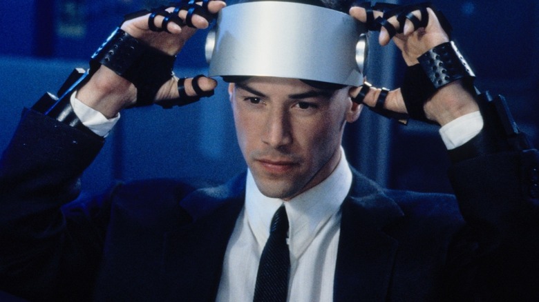 Johnny Mnemonic (Keanu Reeves) putting on a visor