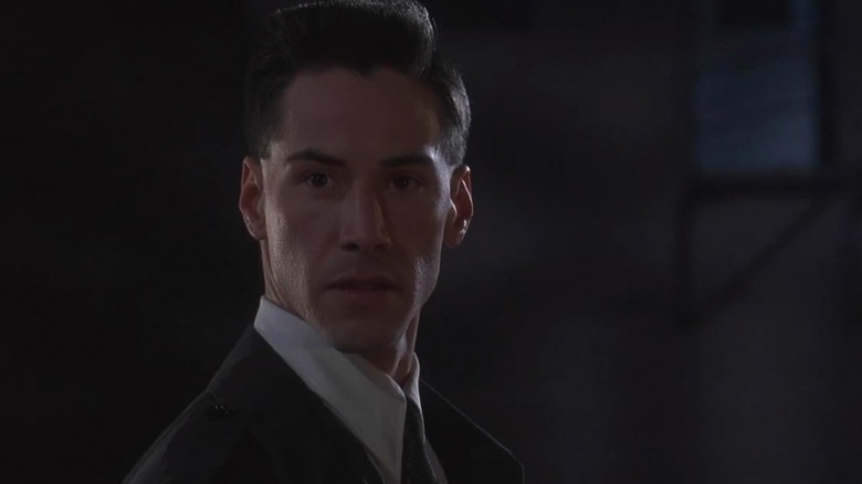 Johnny Mnemonic (Keanu Reeves) in a suit and tie