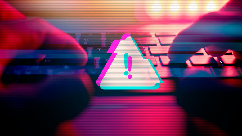 Keyboard in foreground with large warning indicator on screen.