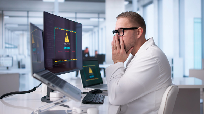 A worker in a business office experience a cyberattack