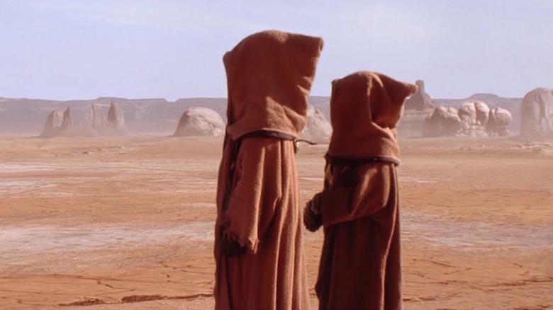 Two Jawas looking at the desert