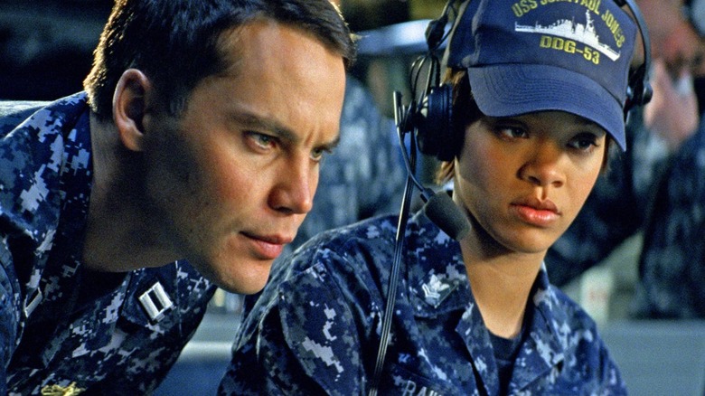 Taylor Kitsch and Rhianna looking at a monitor in Battleship
