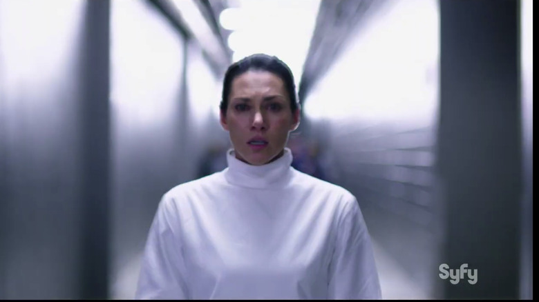 a female character from the sci-fi show Helix standing in a corridor