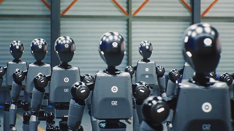 Rows Sleek Humanoid Robots Stand In Formation Under Bright Industrial Lights.