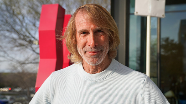 Director Michael Bay standing in front of a theater in Austin, Texas.