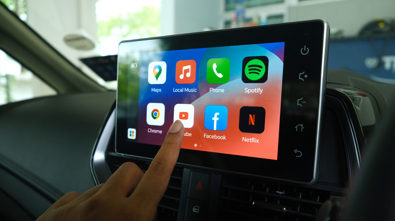 person selecting youtube on an android auto screen