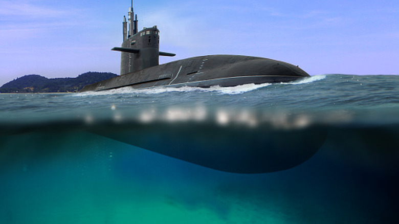A submarine shown half-submerged in water