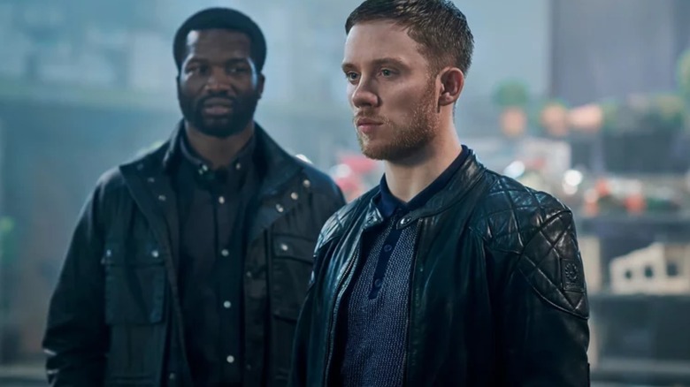 Joe Cole as Sean Wallace and Sope Dirisu as Elliott Finch stood together in Gangs of London