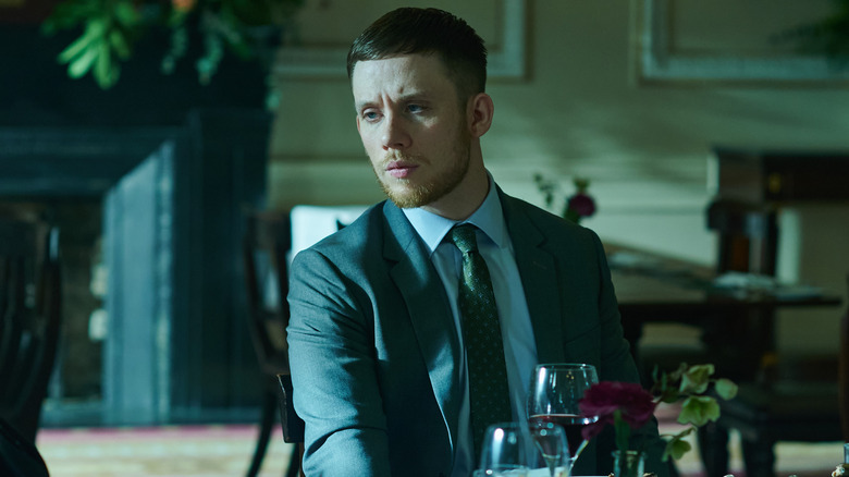 Joe Cole as Sean Wallace sat at a dinner table in Gangs of London