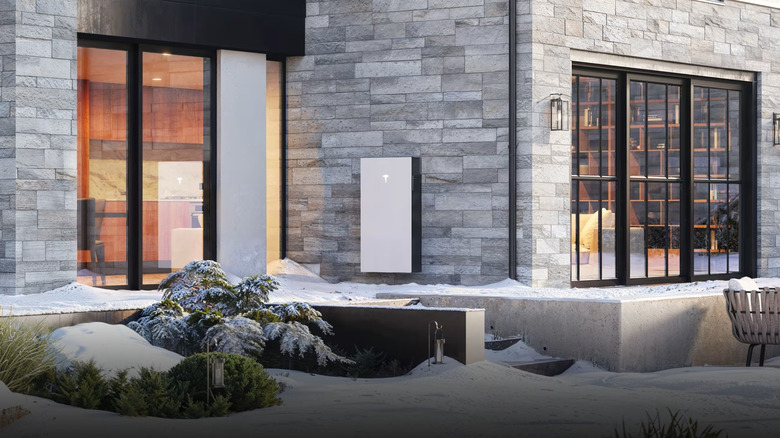 Tesla Powerwall on the outside of a home during winter.