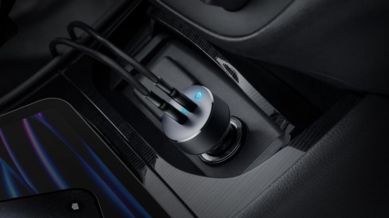 Anker PowerDrive III Duo adapter plugged in with two USB cords connected.