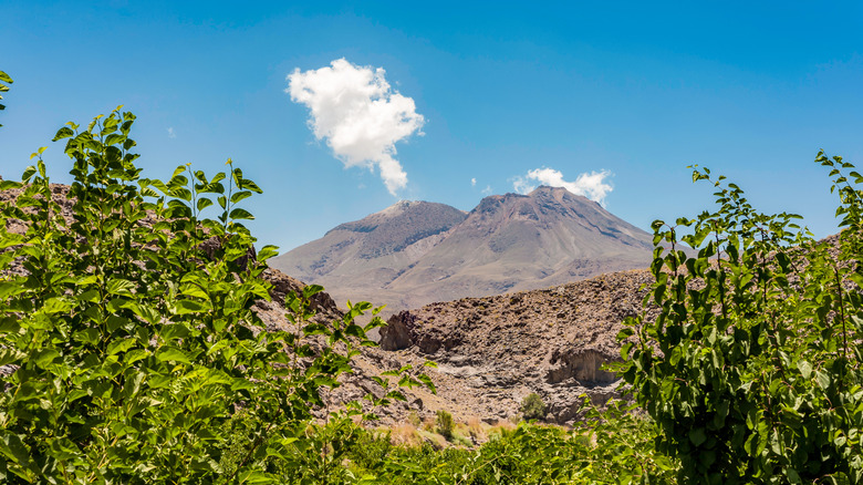 the Taftan volcano in Iran with a blue sky behind it