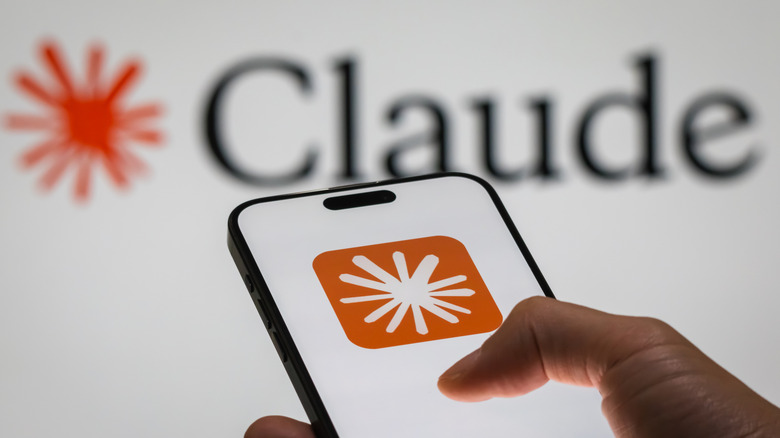 Person running Anthropic Claude on smartphone with logo in background