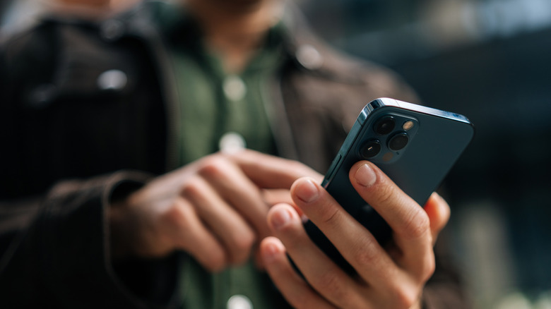 person looking down at smartphone in their hand