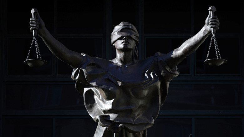 a statue representing blind justice holding scales