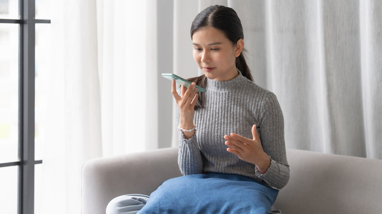 Woman talking to a chatbot on her phone