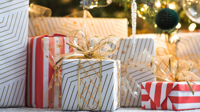 Wrapped holiday gifts under a tree