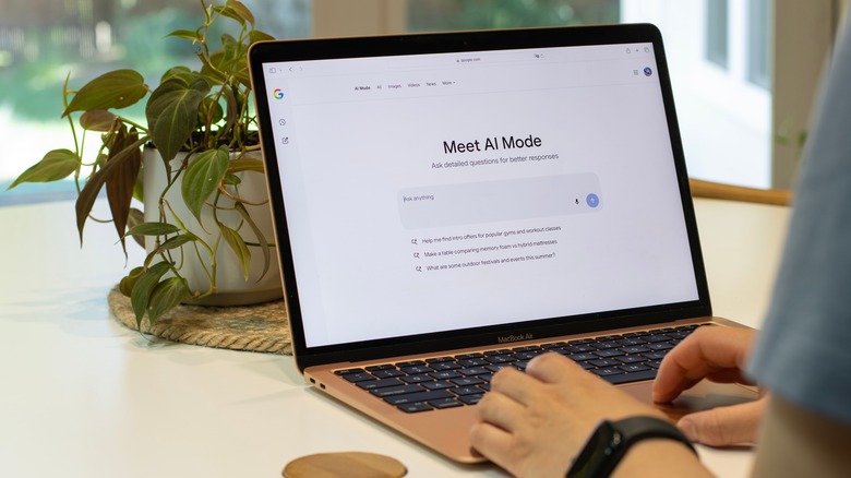 A person using AI Mode in Google Search on a laptop.