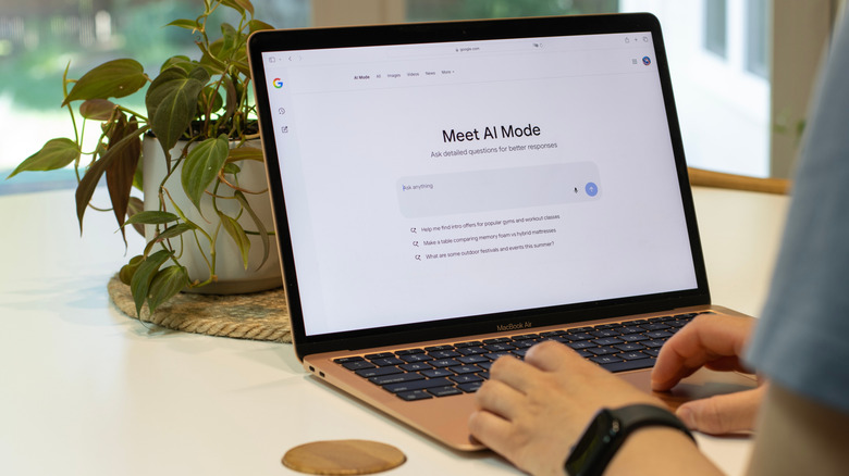 A person using AI Mode on a laptop.