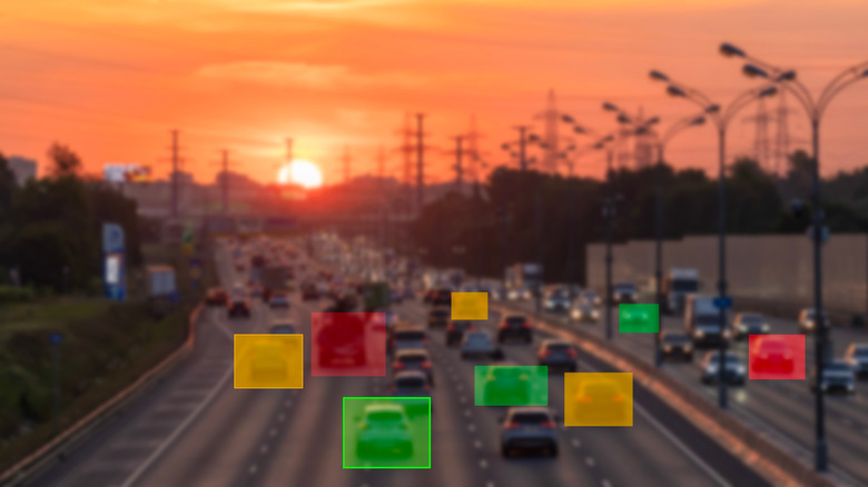 Concept image of AI traffic camera footage monitoring cars on a highway and targeting violators