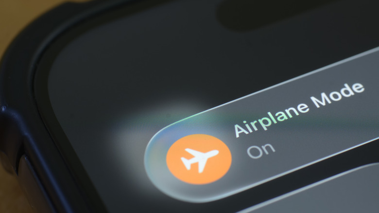 Close up of an iPhone showing the airplane mode status