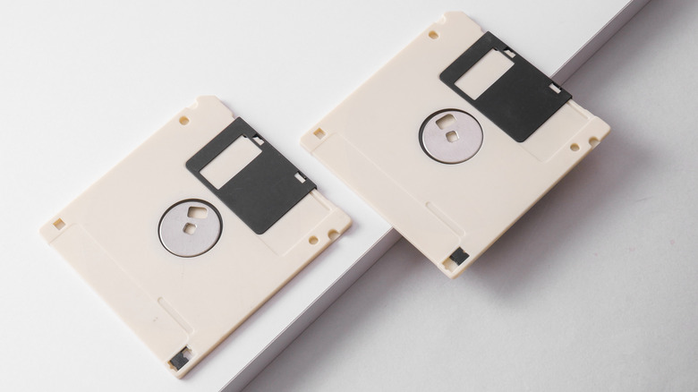 Two floppy disks on a white surface