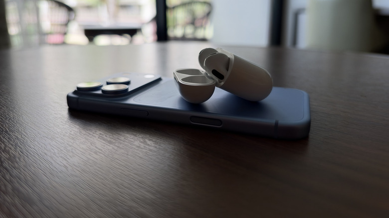 AirPods 5 sat on top of iPhone 18 Pro on a table