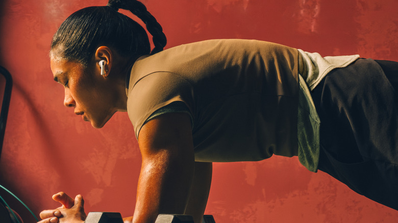 Woman working out with AirPods Pro 3 in her ears