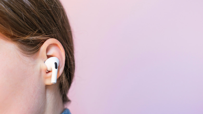 A person wearing AirPods Pro 2 earbuds.