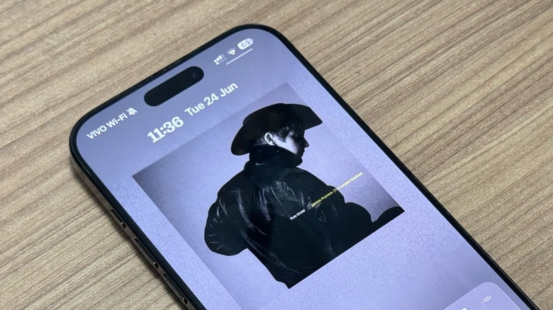 iOS 26's Lock Screen with Apple Music cover