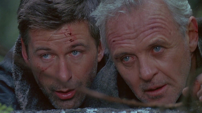 Bob (Alec Baldwin) and Charles (Anthony Hopkins) trying to catch their first prey in The Edge
