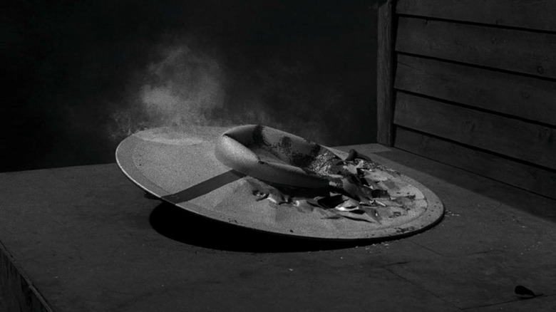 A damaged flying saucer on a roof