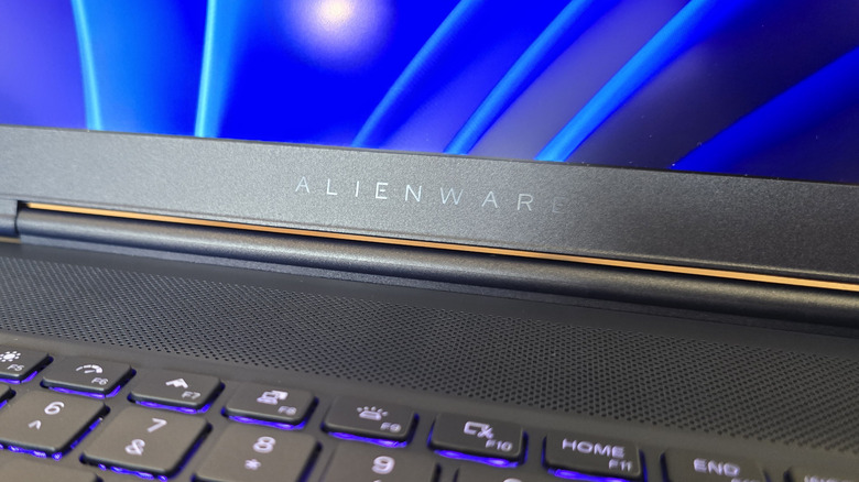 Close up of the Alienware name embossed into a laptop display above the speakers and keyboard