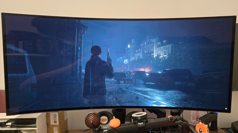 Alienware AW39 5K OLED monitor displaying Leon in front of RPD in 'Resident Evil 2'.